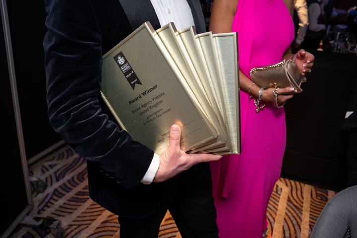 The award plaques fanned out in one hand