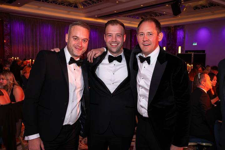 Three of the team in the ballroom