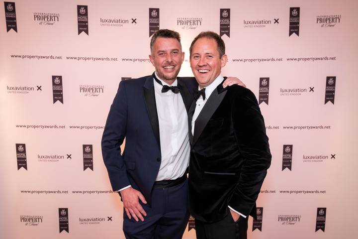 Two of the team at the photo wall