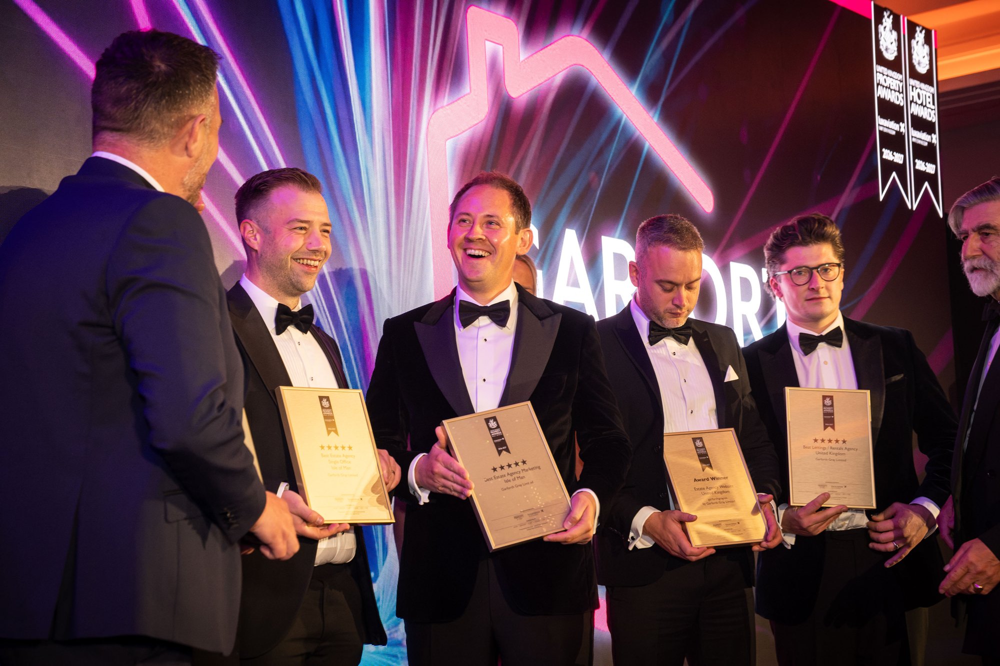 Jonathan Garforth and the team collecting their awards on stage